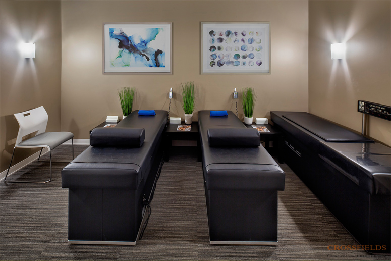 Therapy-room-with-logo-small-chiropractic-clinic-design