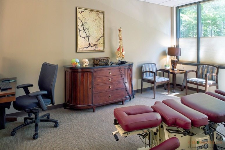 Chiropractic-Treatment-Room-with-logo-chiropractor-clinic-architecture