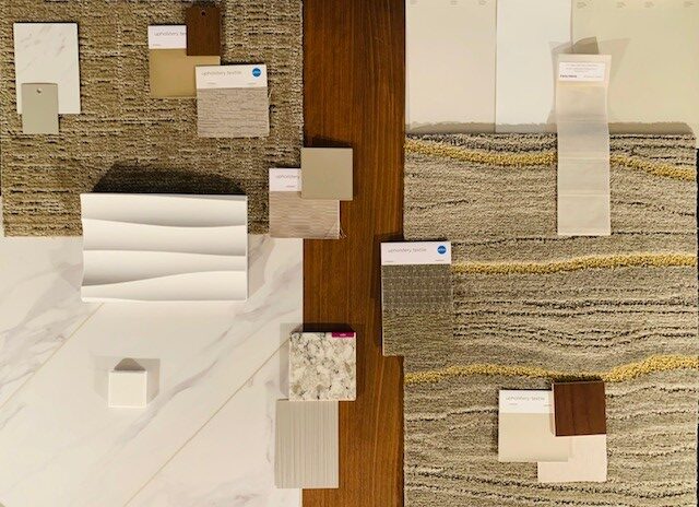 Healthcare office color palette featuring sage green, navy blue, neutral beige and white paint samples with coordinating textures and materials for medical practice design